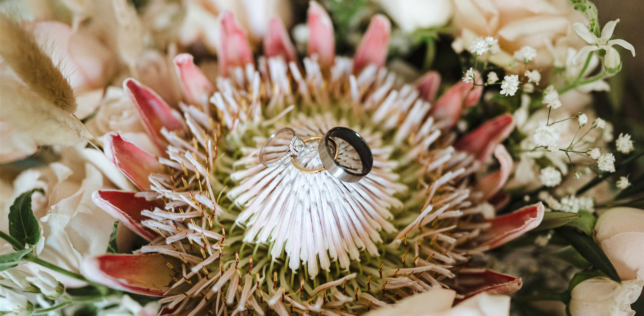 flower bouquet with wedding rings balanced on top