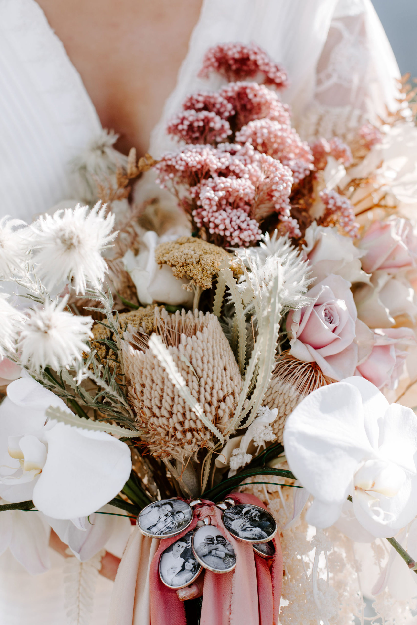 bridal bouquet of flowers with picture lockets attached