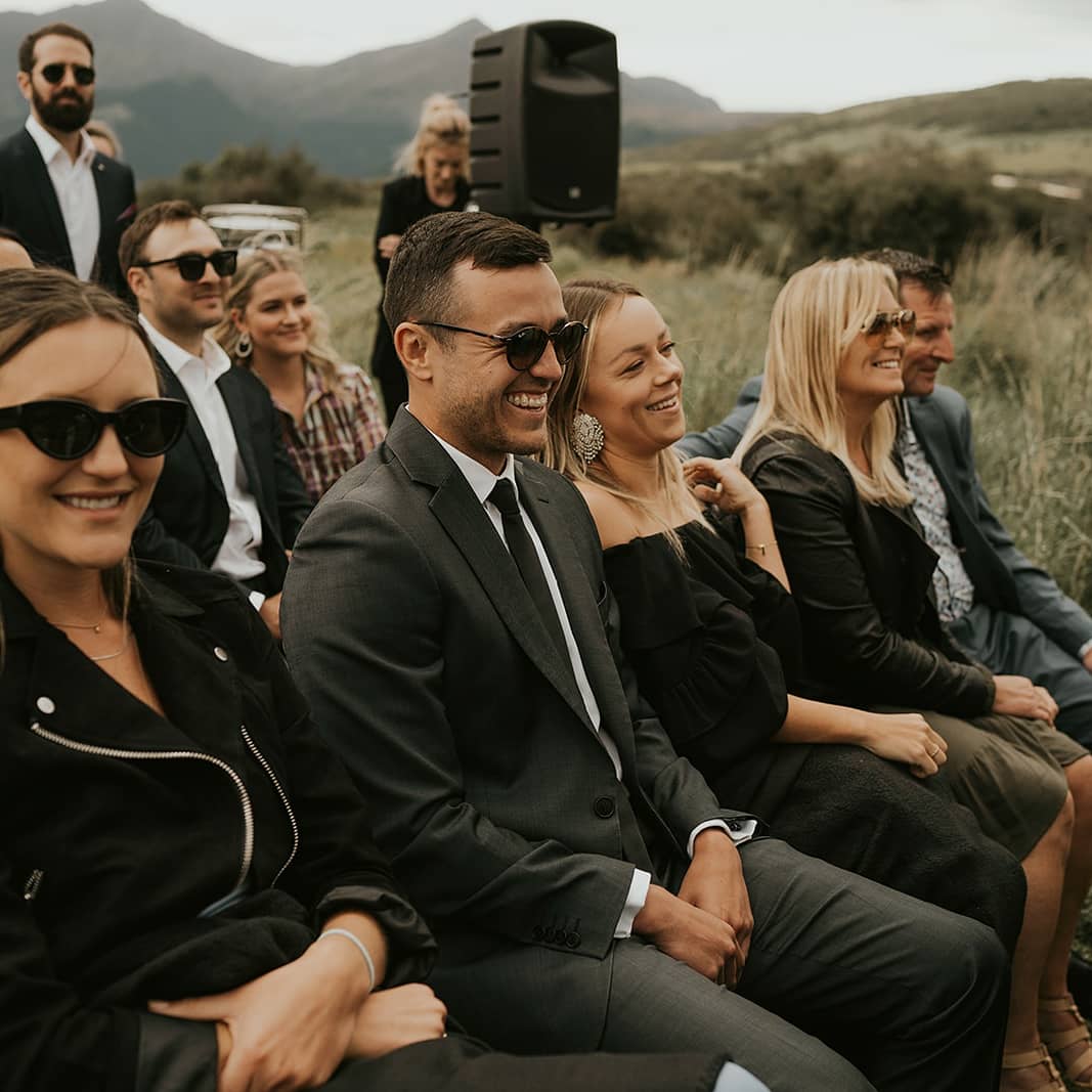 wedding guests laughing during wedding ceremony in Queenstown, New Zealand