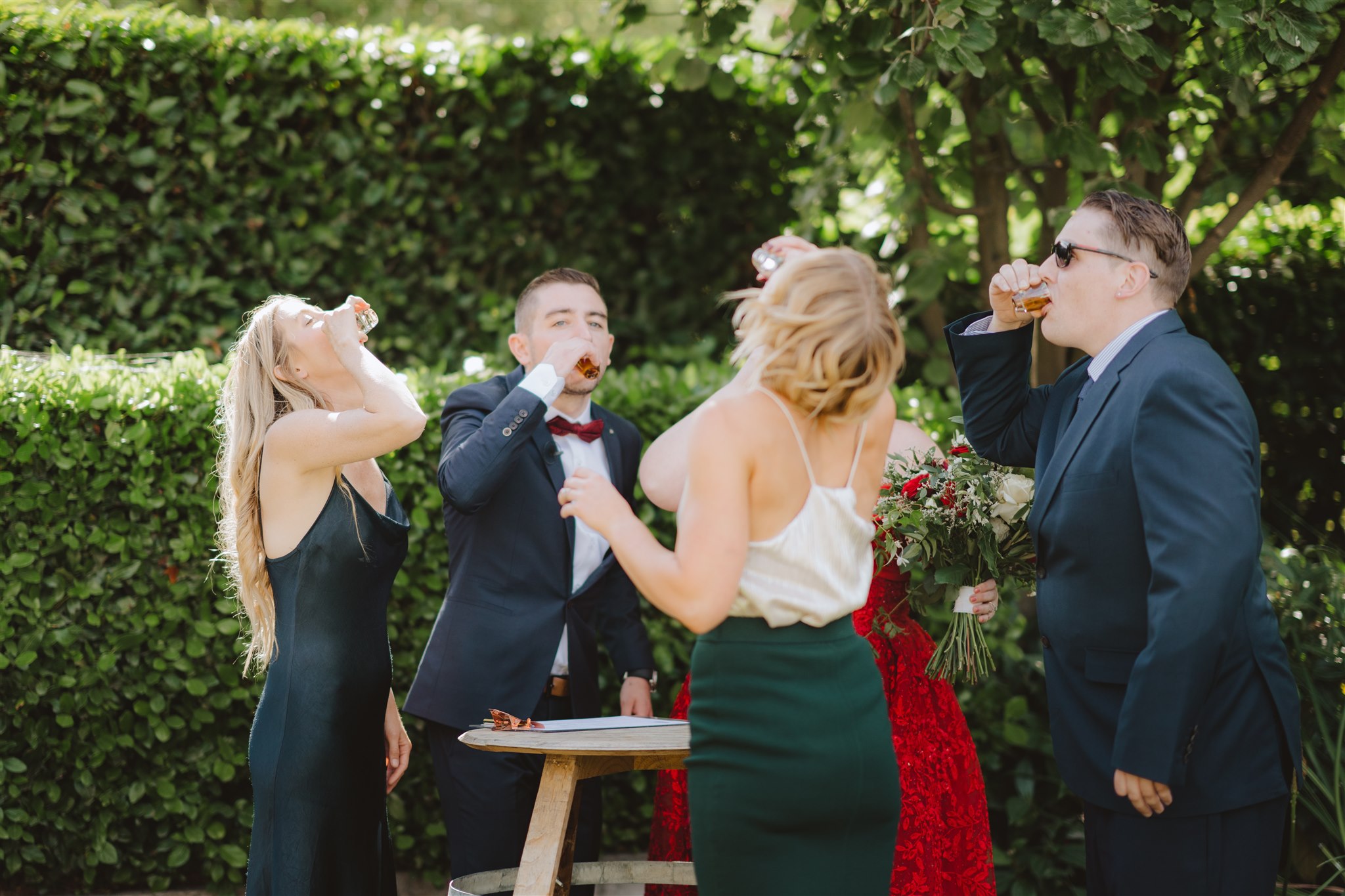 bride and groom take shots with their celebrant and witnesses during wedding ceremony in Queenstown, New Zealand