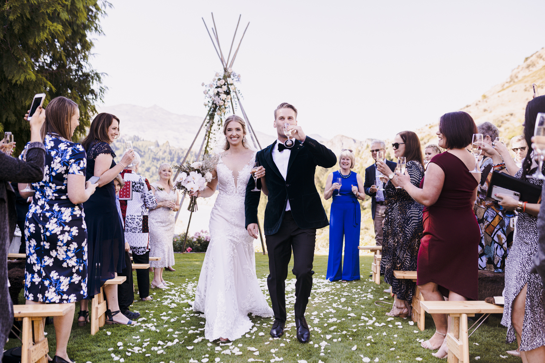 Bride and groom exit their wedding ceremony after a champagne toast in Queenstown, New Zealand