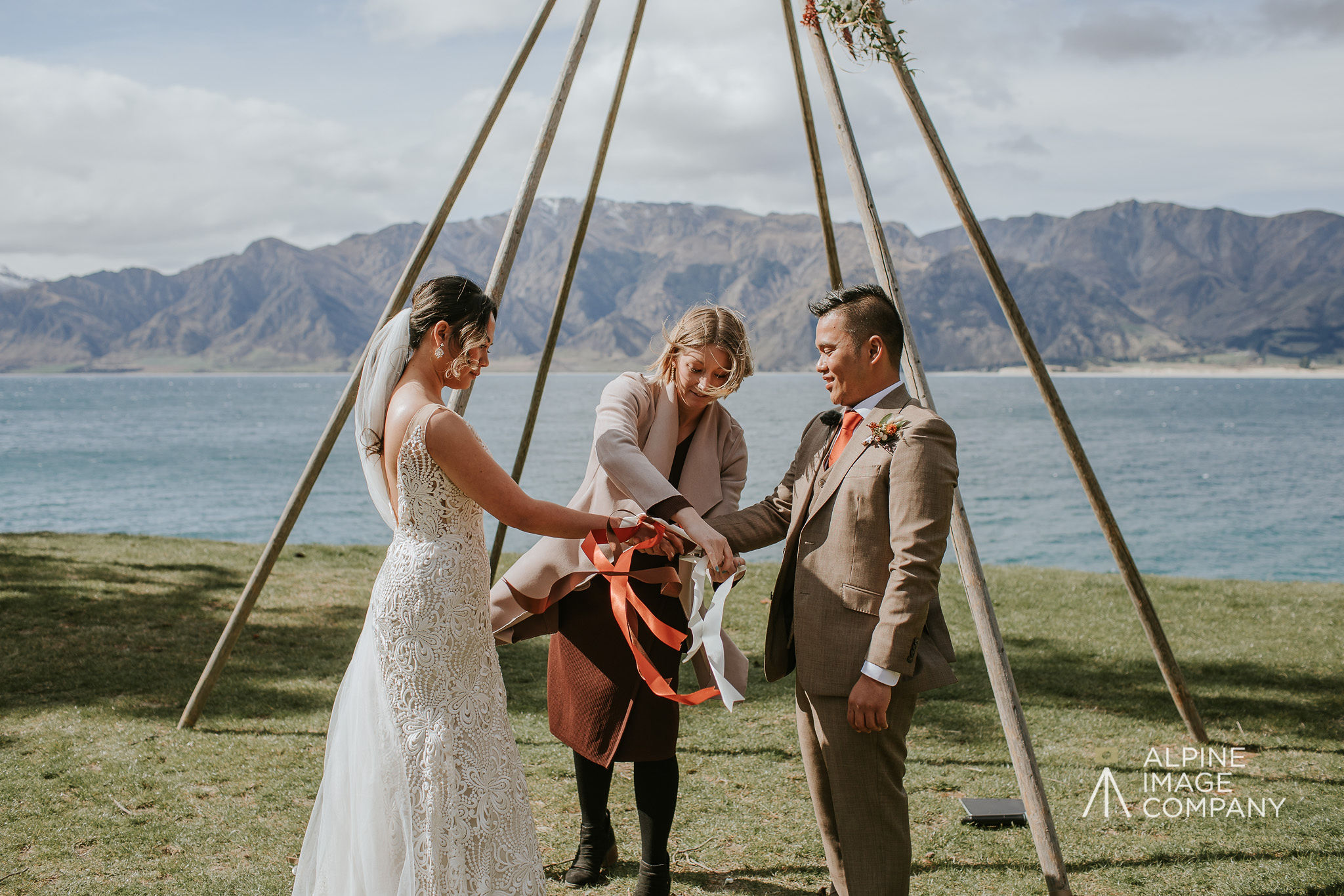 hand fasting with ribbons during wedding ceremony at The Camp, Wanaka, New Zealand