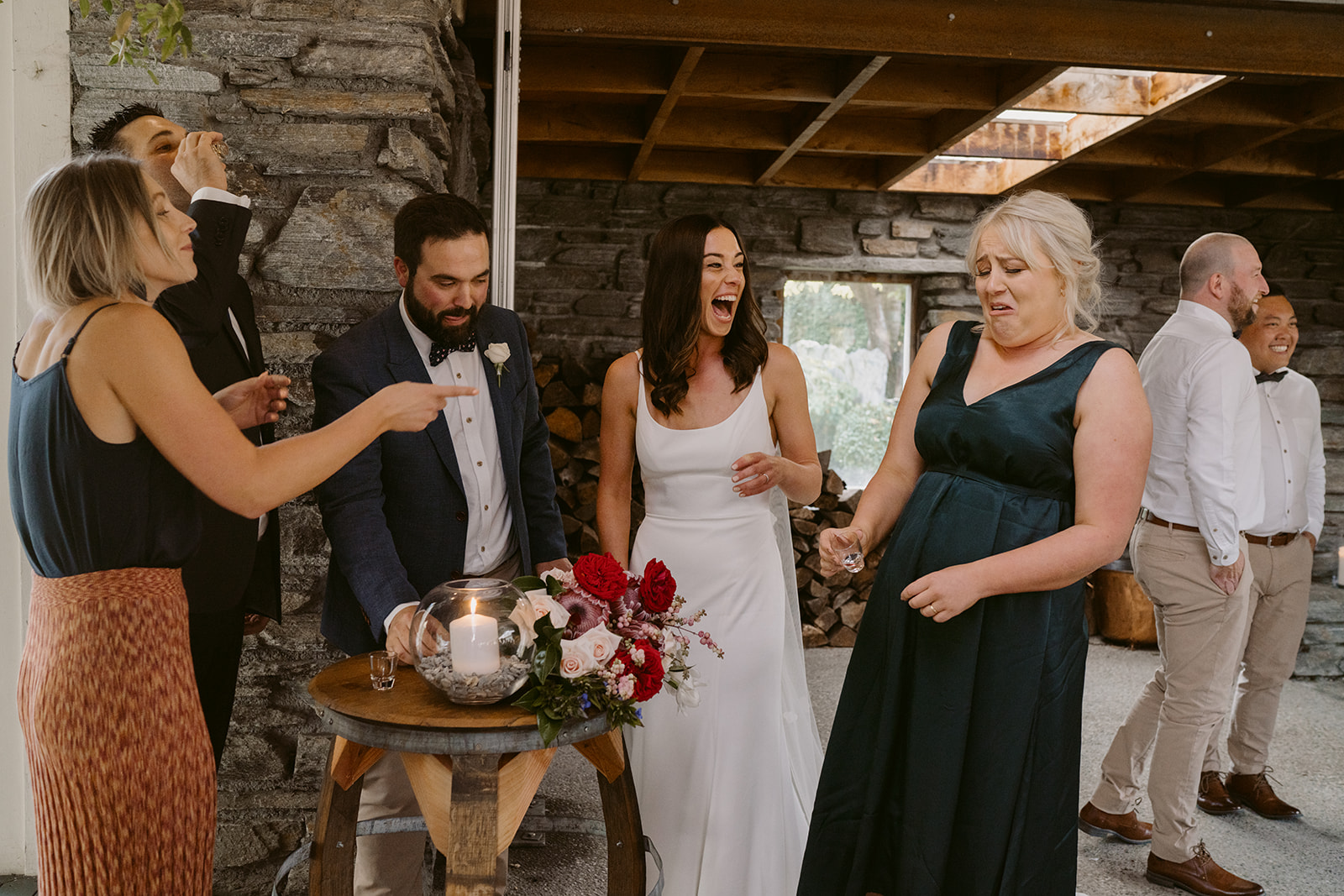 bride and groom take shots with celebrant and witnesses during wedding ceremony at Winehouse in Queenstown, New Zealand