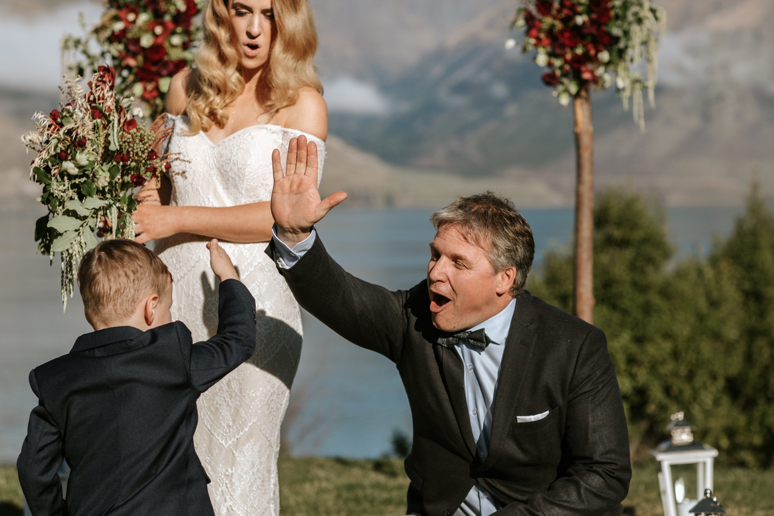 Marriage celebrant high fives with ring boy at Queenstown wedding in New Zealand