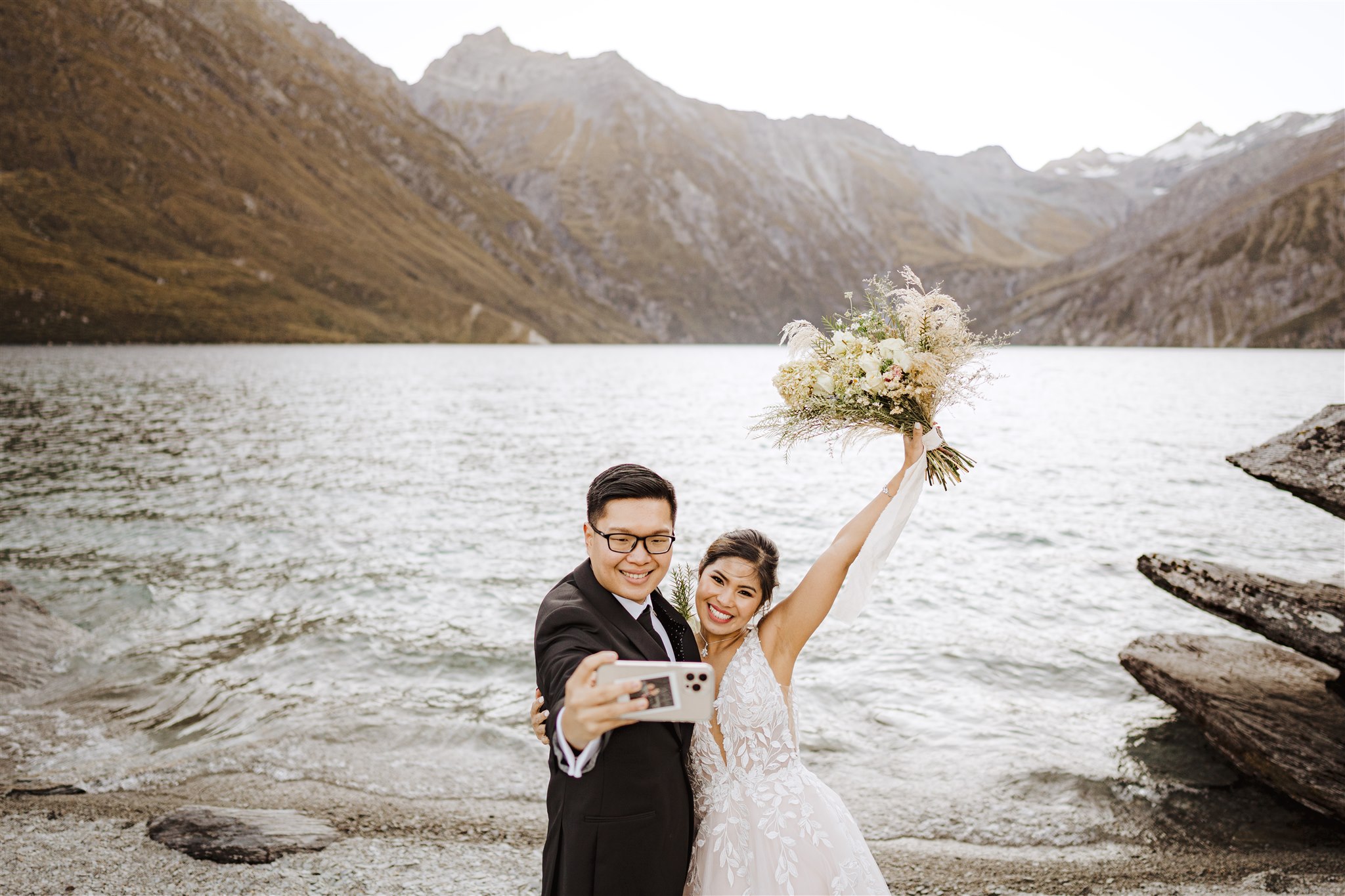 bride and groom take selfie after wedding ceremony at Lochnagar in Queenstown, New Zealand